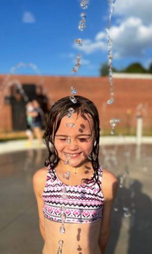girl at splash pad 301x500